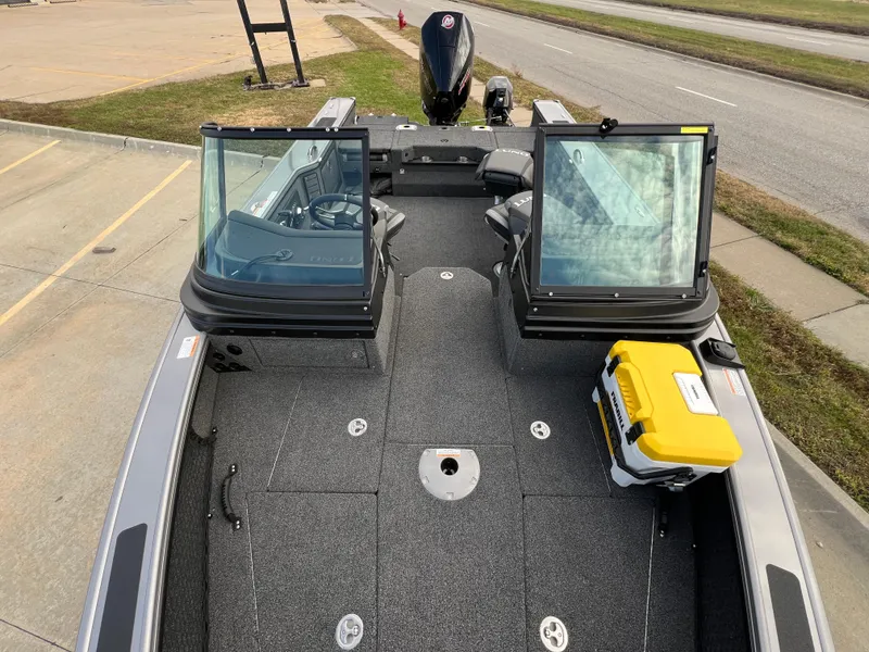 Slide: The Image of 2024 Lund 1875 Pro-V boat with open windshield and yellow cooler on deck. - 10