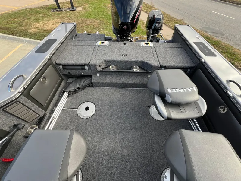 Slide: The Image of 2024 Lund 1875 Pro-V boat interior with seating and storage compartments. - 16