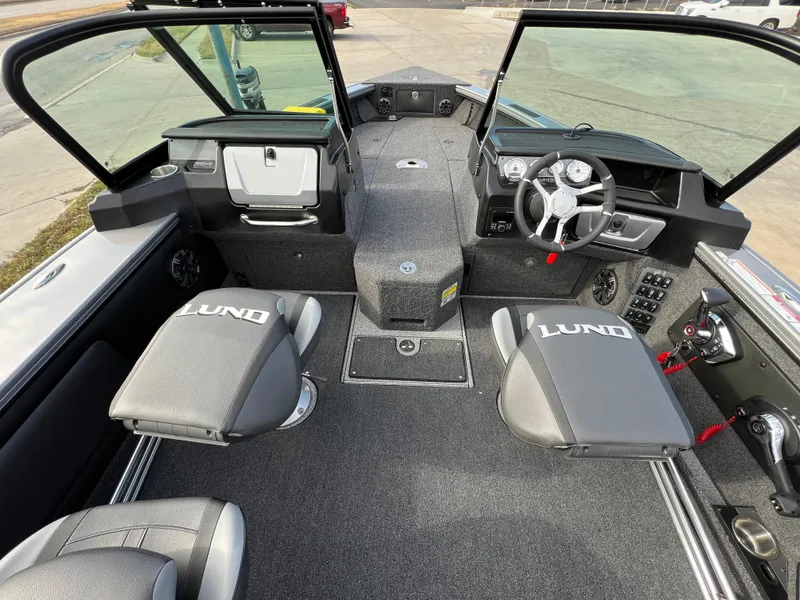 Slide: The Image of 2024 Lund 1875 Pro-V boat interior with steering wheel and seating. - 18