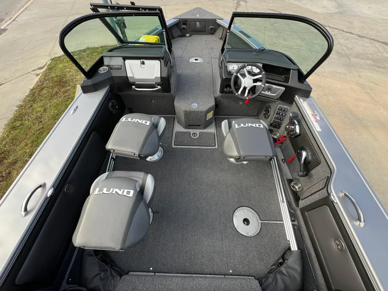 Slide: The Image of 2024 Lund 1875 Pro-V boat interior with seating and steering console. - 19