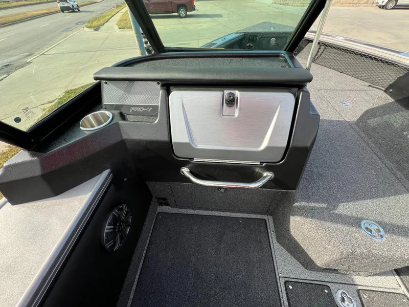Slide: The Image of 2024 Lund 1875 Pro-V boat interior with storage compartment and cup holder. - 20