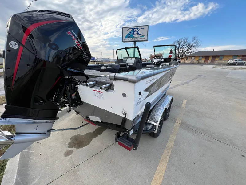 Slide: The Image of 2024 Lund 1875 Pro-V boat with powerful outboard motor in parking lot. - 8