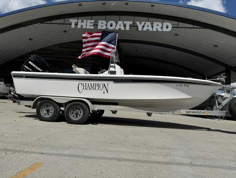 Slide: The Image of 2007 Champion 220 Bay boat with American flag at The Boat Yard. - 11