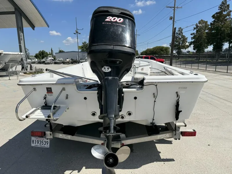 Slide: The Image of 2007 Champion 220 Bay boat with outboard motor on trailer. - 5
