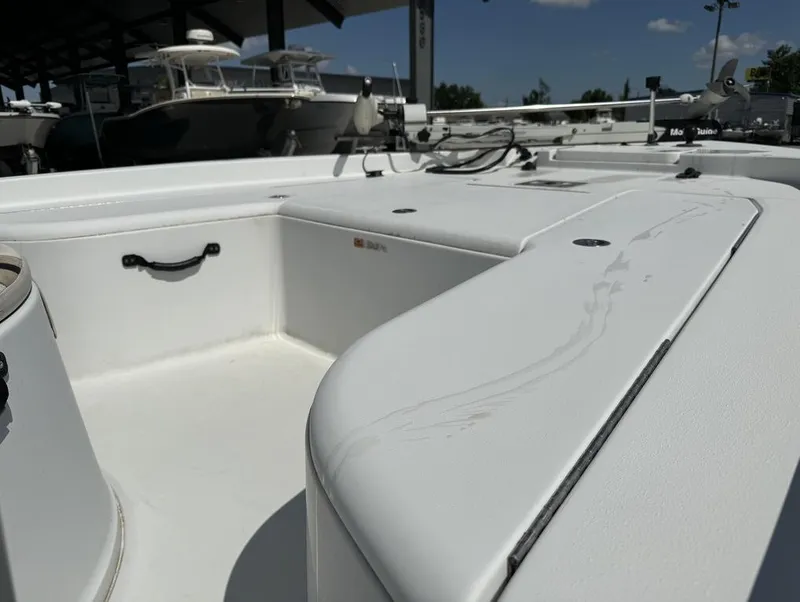 Slide: The Image of 2007 Champion 220 Bay boat interior with clean white deck and storage compartments. - 8