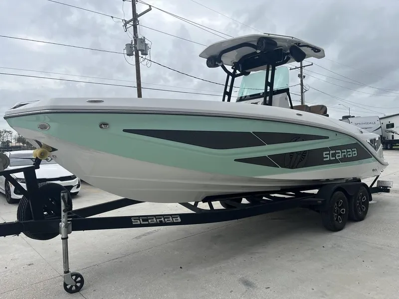 Slide: The Image of 2022 Scarab 255 Open ID boat on trailer, mint green and white design. - 10