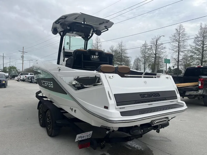 Slide: The Image of 2022 Scarab 255 Open ID boat on trailer, parked outdoors. - 13