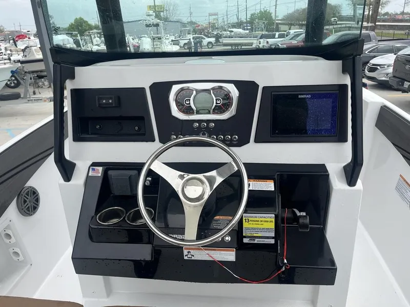 Slide: The Image of 2022 Scarab 255 Open ID boat dashboard with steering wheel and navigation display. - 15