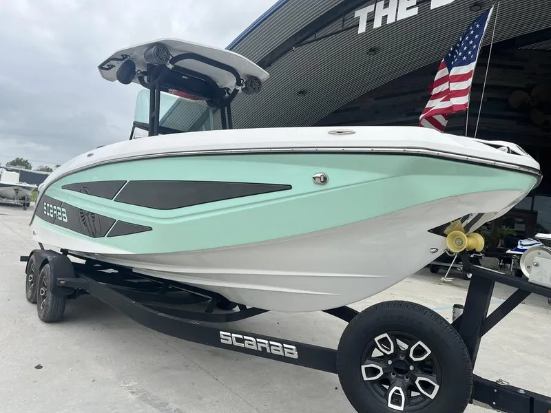 Slide: The Image of 2022 Scarab 255 Open ID boat on trailer with American flag. - 3