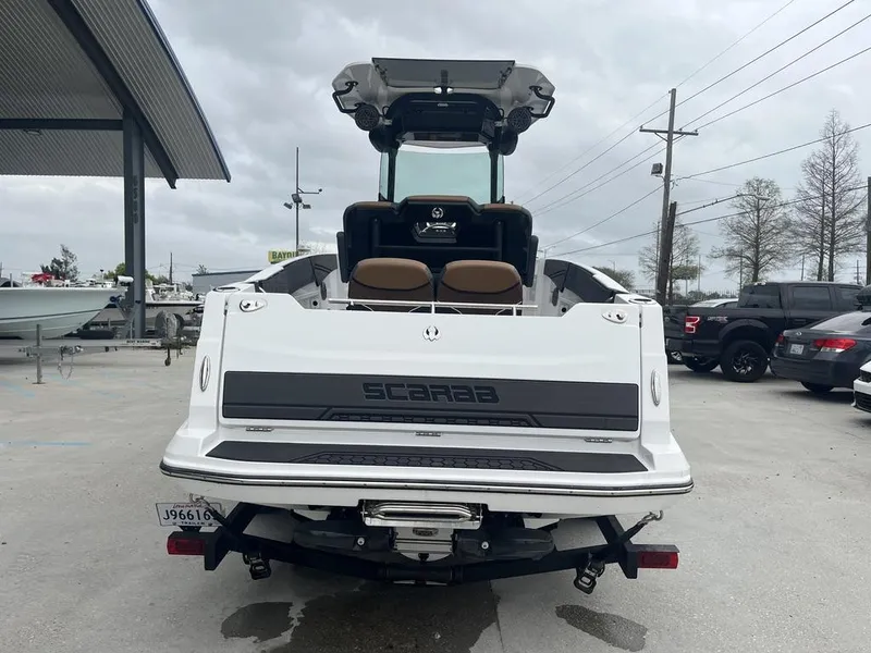Slide: The Image of 2022 Scarab 255 Open ID boat, rear view in a dealership lot. - 4
