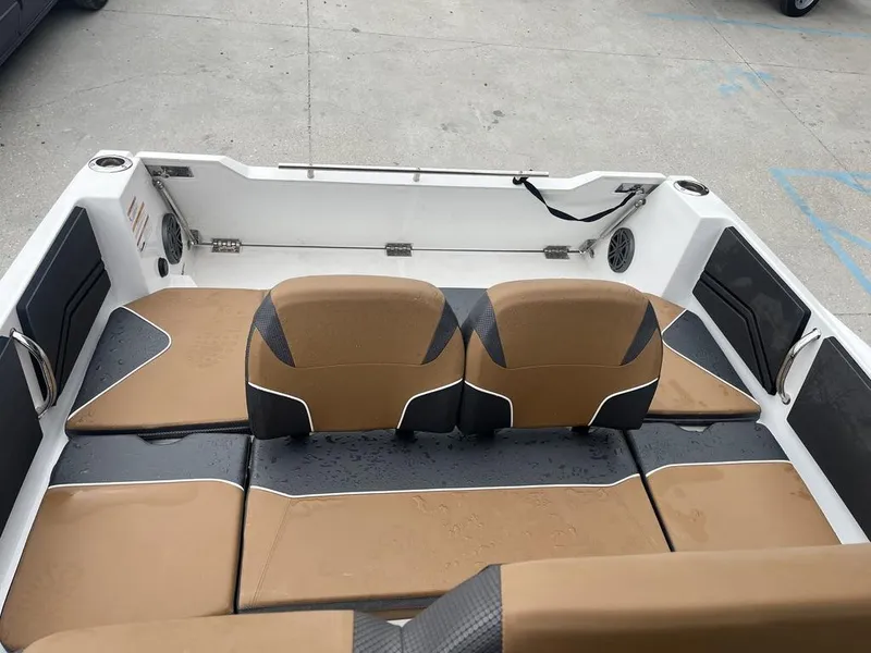Slide: The Image of 2022 Scarab 255 Open ID boat interior with tan and black seating. - 6