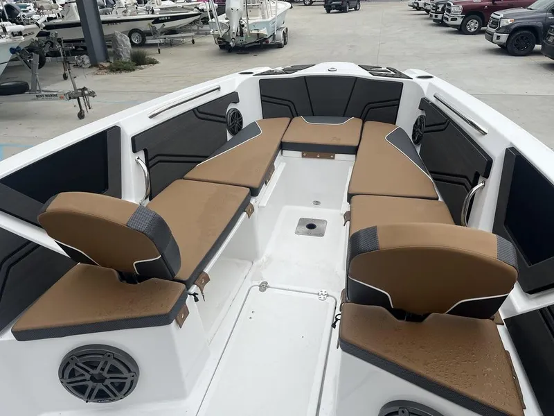 Slide: The Image of 2022 Scarab 255 Open ID boat interior with tan and black seating. - 7