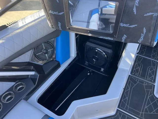 Slide: The Image of 2020 Tigé 23ZX boat interior with storage compartment and speaker system. - 12
