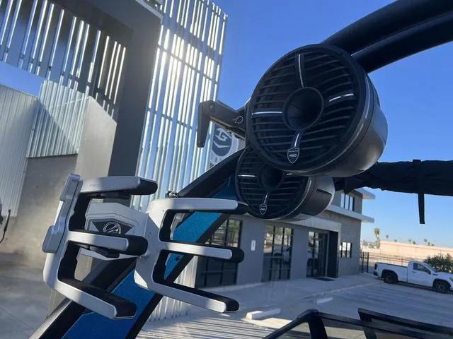 Slide: The Image of 2020 Tigé 23ZX boat speakers and wakeboard rack in a modern marina setting. - 13