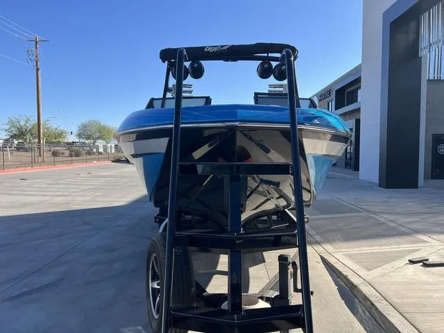 Slide: The Image of 2020 Tigé 23ZX boat on trailer, blue exterior, parked outdoors. - 3