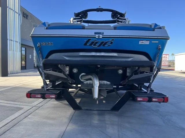 Slide: The Image of Rear view of a 2020 Tigé 23ZX boat on a trailer, showcasing its sleek design. - 7