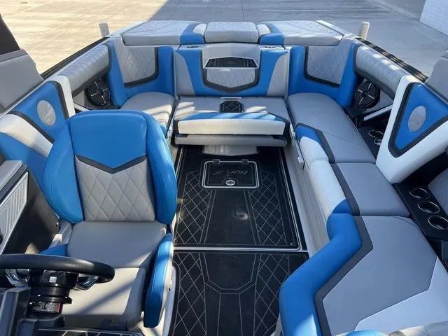 Slide: The Image of 2020 Tigé 23ZX boat interior with blue and gray seating, modern design. - 8