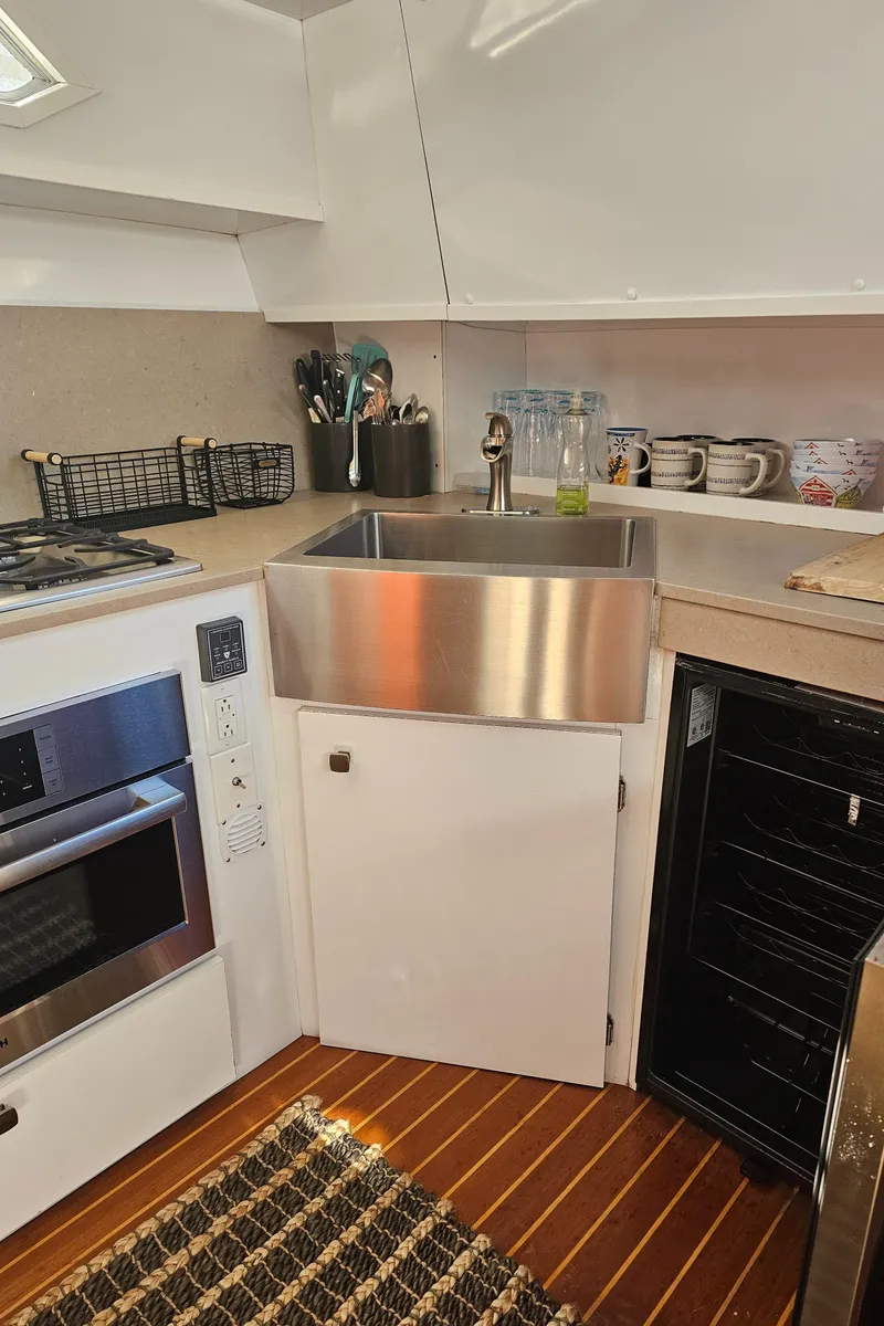 Slide: The Image of 1988 Sea Ray 390 Express Cruiser kitchen with stainless steel sink and modern appliances. - 11