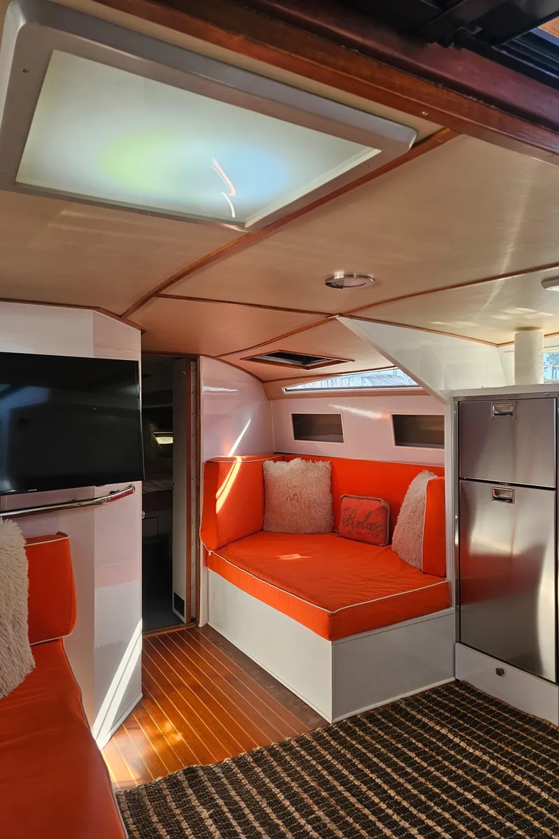 Slide: The Image of Interior of 1988 Sea Ray 390 Express Cruiser with orange seating and modern decor. - 2