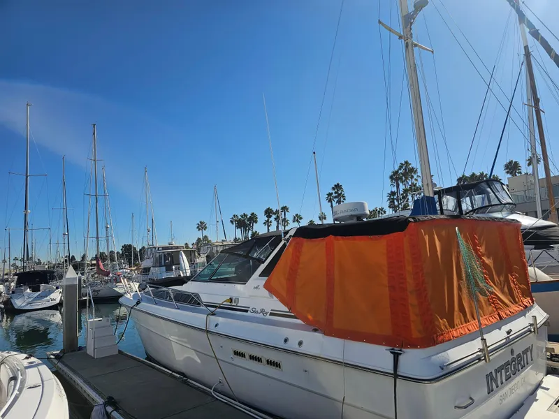 Slide: The Image of 1988 Sea Ray 390 Express Cruiser docked at marina under clear blue sky. - 20