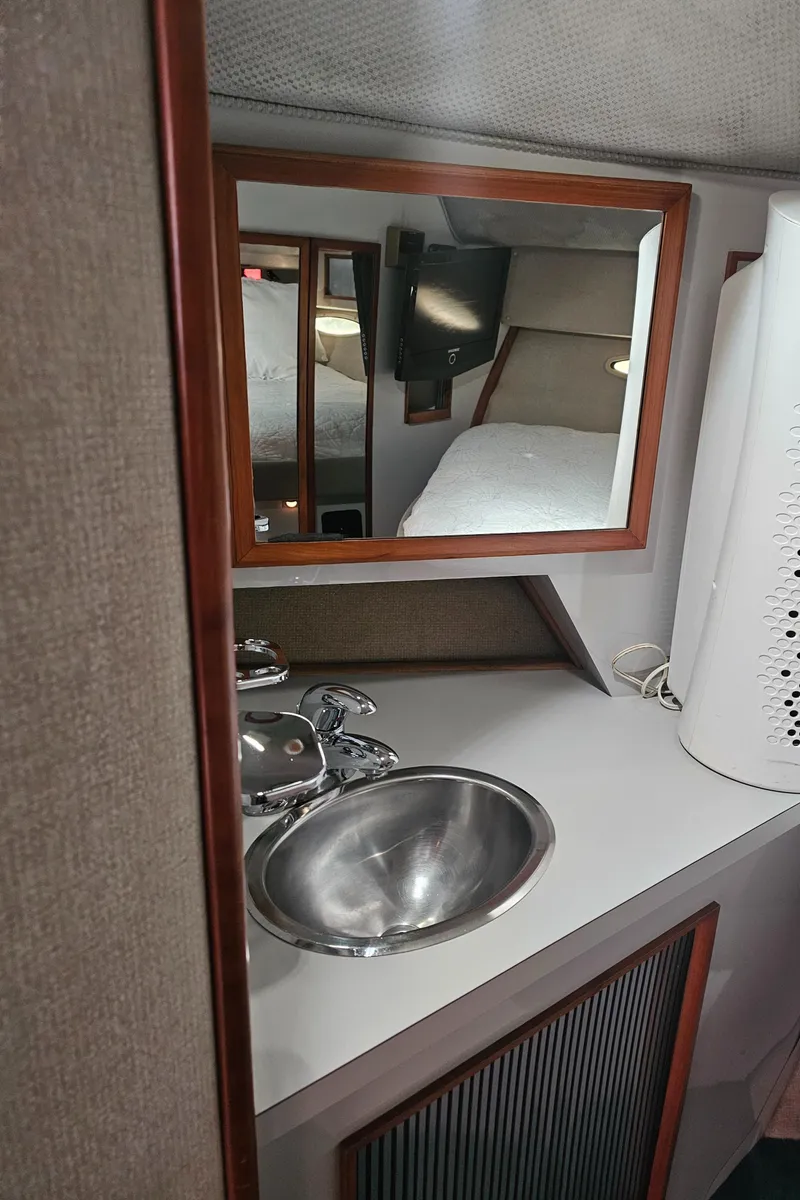 Slide: The Image of 1988 Sea Ray 390 Express Cruiser bathroom with sink and mirror. - 25