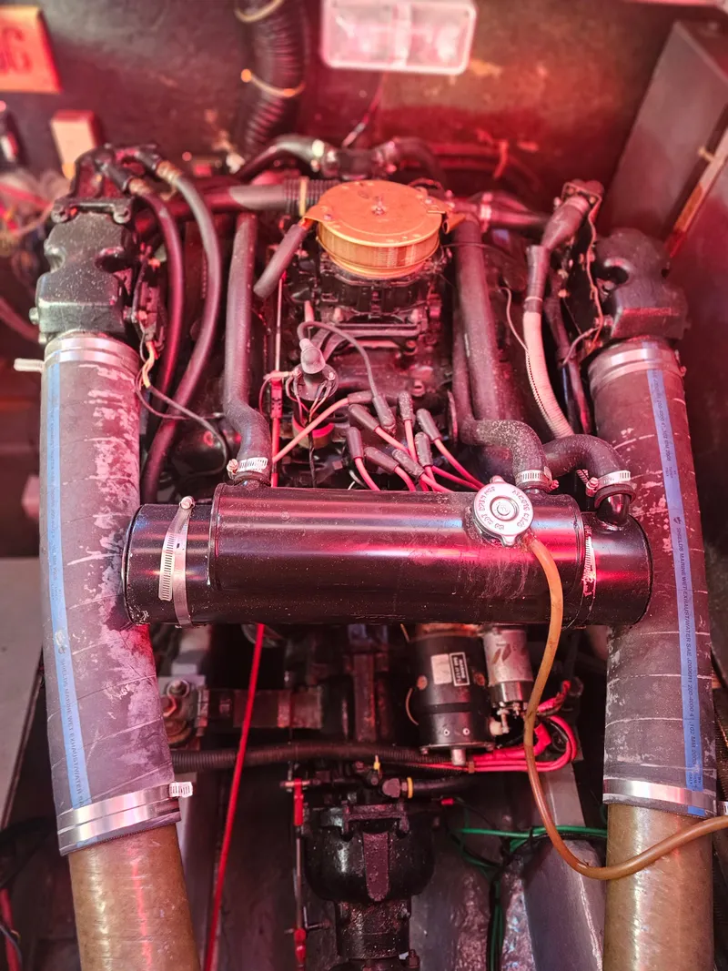 Slide: The Image of Engine compartment of a 1988 Sea Ray 390 Express Cruiser with visible components and wiring. - 29