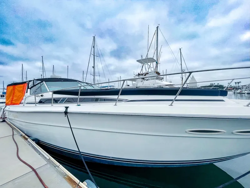 Slide: The Image of 1988 Sea Ray 390 Express Cruiser docked at marina under cloudy sky. - 4