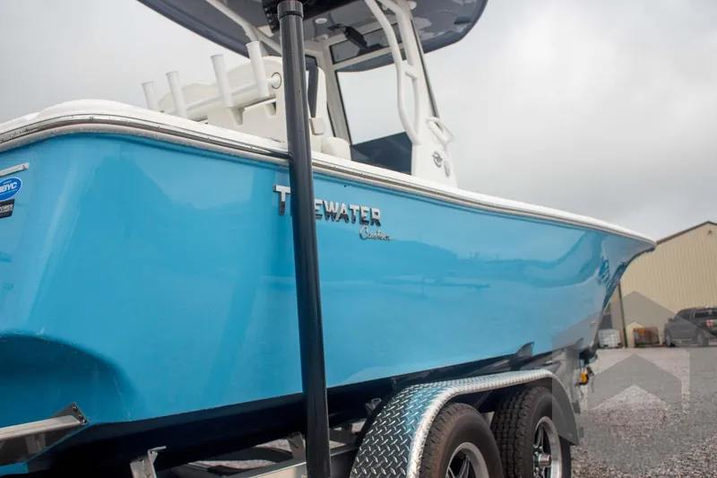 Slide: The Image of 2025 Tidewater 2500 Carolina Bay boat in vibrant blue on a trailer. - 17