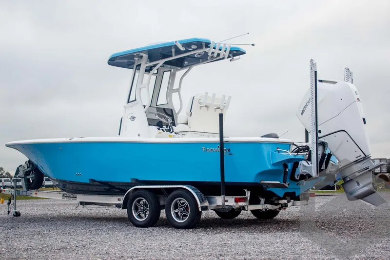 Slide: The Image of 2025 Tidewater 2500 Carolina Bay boat on trailer, blue hull, outboard motor. - 3