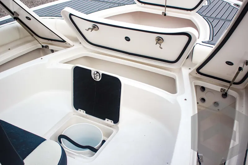 Slide: The Image of 2025 Tidewater 2500 Carolina Bay boat interior with storage compartments open. - 32