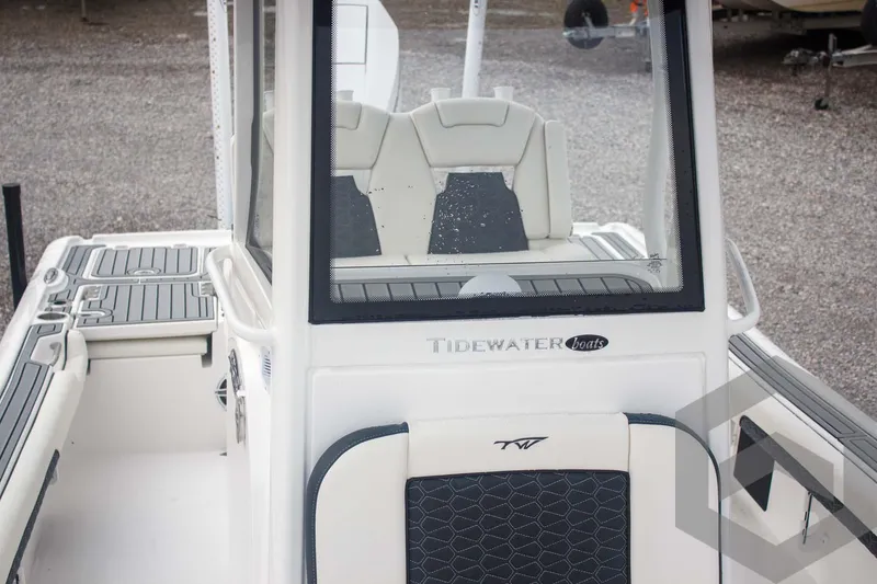 Slide: The Image of 2025 Tidewater 2500 Carolina Bay boat interior with modern seating and console design. - 33