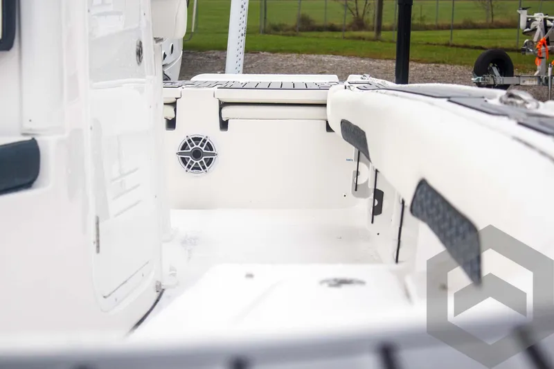 Slide: The Image of 2025 Tidewater 2500 Carolina Bay boat interior with white seating and speaker. - 35