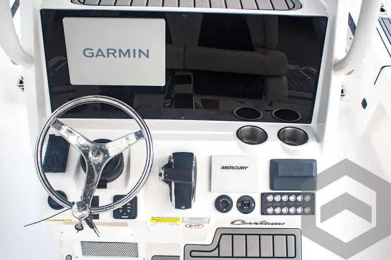 Slide: The Image of 2025 Tidewater 2500 Carolina Bay boat dashboard with Garmin display and Mercury controls. - 40
