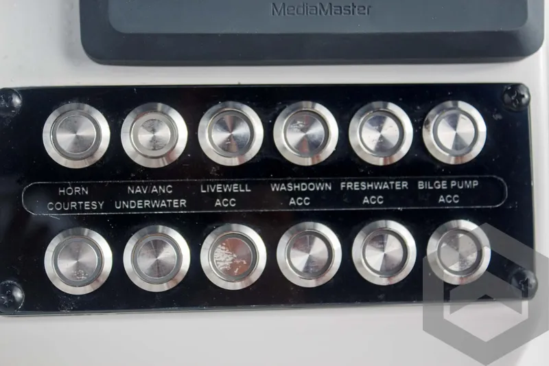 Slide: The Image of Control panel of 2025 Tidewater 2500 Carolina Bay boat with labeled buttons. - 45