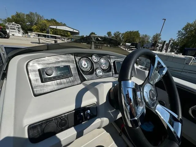 Slide: The Image of 2021 Tahoe LTZ Versatile Rear Lounger 24' boat dashboard with steering wheel and gauges. - 13
