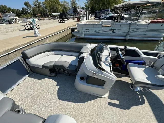 Slide: The Image of 2021 Tahoe LTZ Versatile Rear Lounger 24' pontoon boat interior at marina. - 15