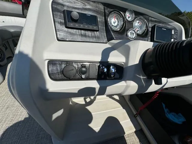 Slide: The Image of Dashboard of 2021 Tahoe LTZ Versatile Rear Lounger 24' boat with gauges and controls. - 19