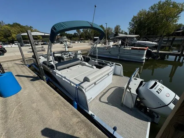Slide: The Image of 2021 Tahoe LTZ Versatile Rear Lounger 24' pontoon boat docked at marina. - 3