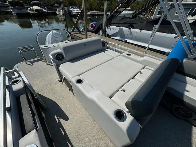 Slide: The Image of 2021 Tahoe LTZ Versatile Rear Lounger 24' boat with spacious seating at dock. - 5