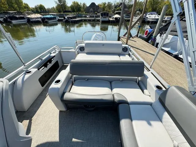 Slide: The Image of 2021 Tahoe LTZ Versatile Rear Lounger 24' boat interior at a marina. - 6
