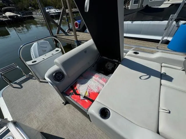 Slide: The Image of 2021 Tahoe LTZ Versatile Rear Lounger 24' boat interior with open storage compartment. - 8