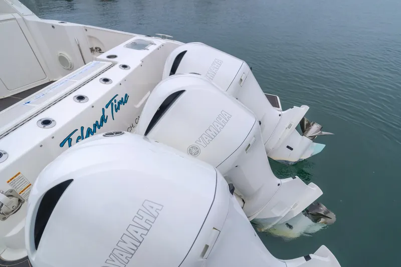 Slide: The Image of 2018 Pursuit 365 DC boat with triple Yamaha outboard engines on water. - 19