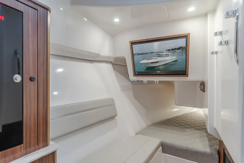 Slide: The Image of Interior of 2018 Pursuit 365 DC boat with seating and wall-mounted TV. - 20