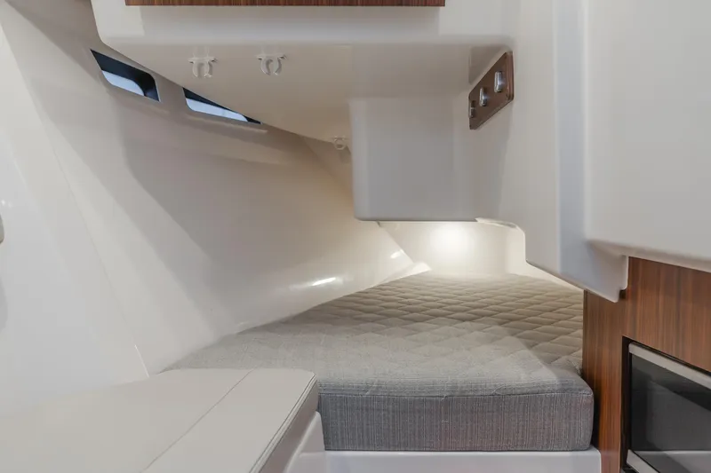 Slide: The Image of Interior cabin of 2018 Pursuit 365 DC boat with cushioned bed and modern design. - 21