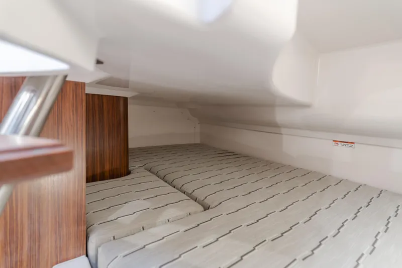 Slide: The Image of Interior cabin of 2018 Pursuit 365 DC boat with striped bedding. - 23