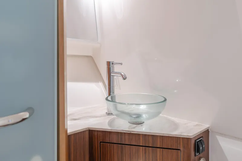 Slide: The Image of Modern bathroom sink in 2018 Pursuit 365 DC boat, featuring glass basin and sleek faucet. - 25