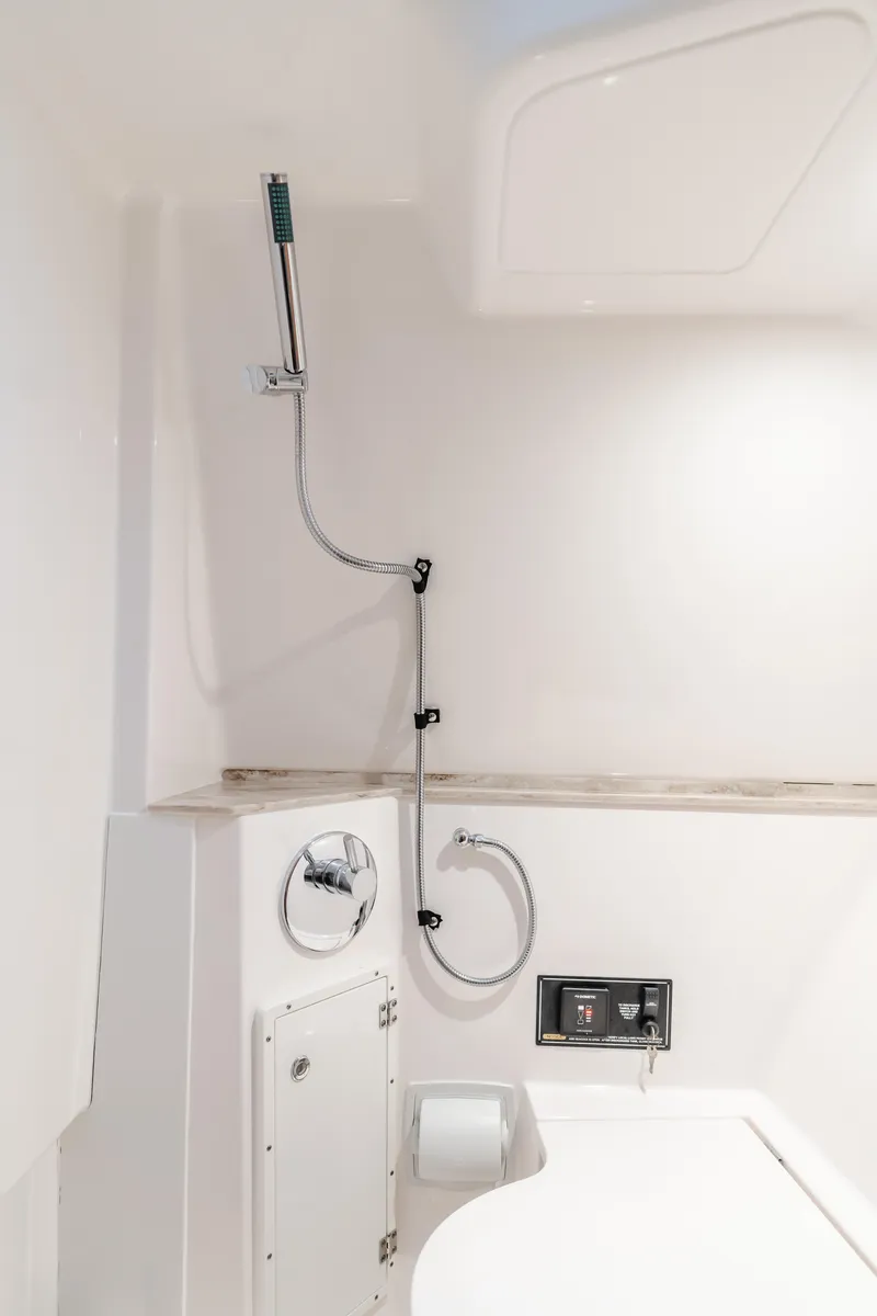 Slide: The Image of 2018 Pursuit 365 DC boat interior shower area with modern fixtures. - 27