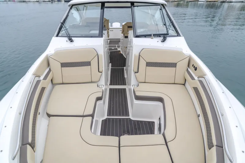 Slide: The Image of 2018 Pursuit 365 DC boat with spacious seating and sleek design on calm water. - 29