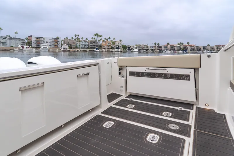 Slide: The Image of 2018 Pursuit 365 DC boat deck with waterfront view and modern design. - 33