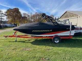 Slide: The Image of 2014 Moomba Mondo boat on trailer, covered, parked on grass. - 1